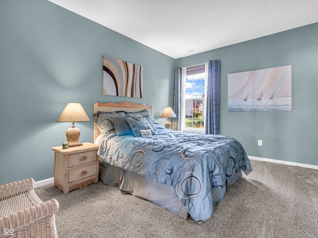 bedroom featuring lofted ceiling, carpet floors, and a textured ceiling