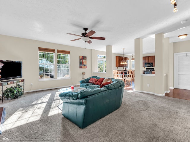 carpeted living room featuring ceiling fan