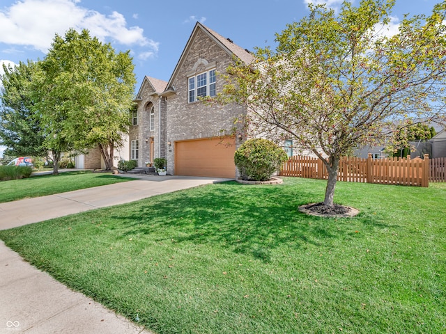 view of front of house featuring a garage and a front lawn