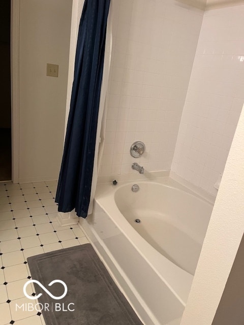 bathroom with shower / bath combo with shower curtain and tile patterned floors