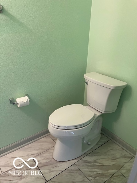 bathroom featuring tile patterned floors and toilet