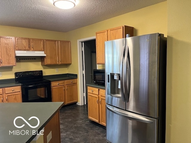 kitchen featuring electric stove, a textured ceiling, stainless steel fridge, and dark tile patterned flooring