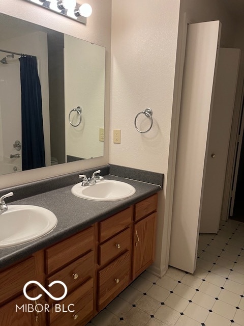 bathroom with tile patterned floors, vanity, and shower / bath combo