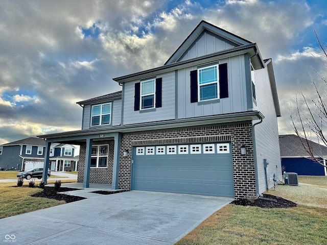 front of property with cooling unit, a garage, and a front yard