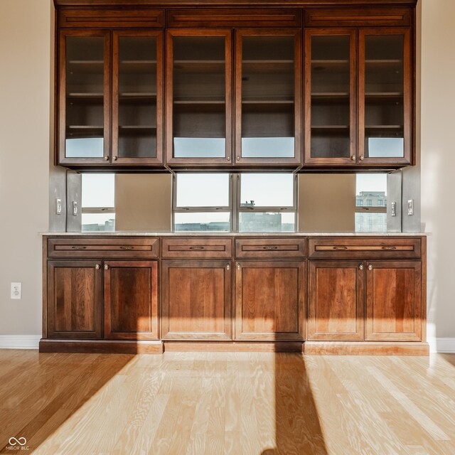 bar with light hardwood / wood-style flooring