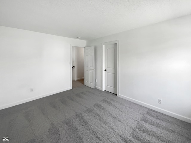 unfurnished room featuring carpet