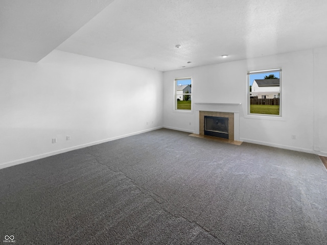 unfurnished living room featuring a fireplace and carpet flooring