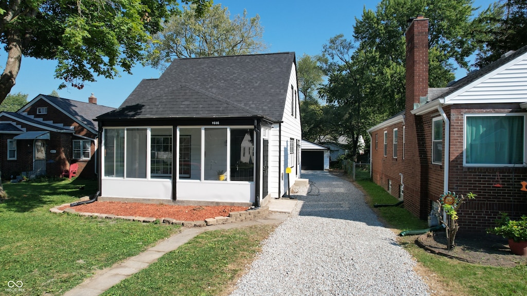 exterior space with a sunroom and a yard