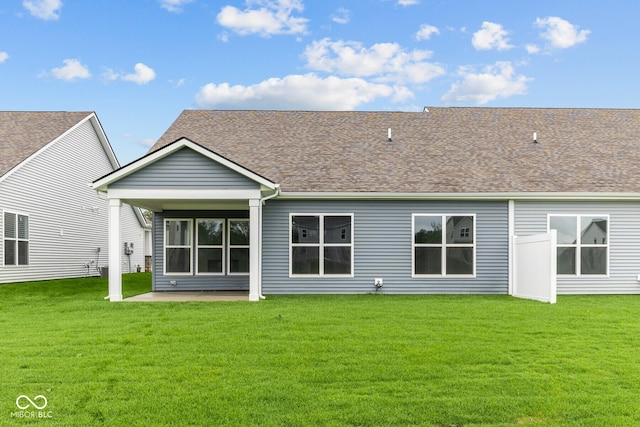 back of house with a yard and a patio area