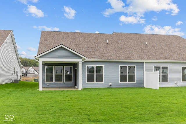 back of house with a lawn