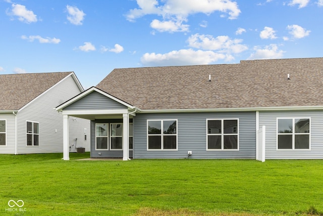 back of house featuring a lawn