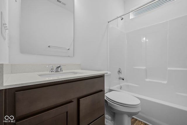 full bathroom with hardwood / wood-style flooring, vanity, toilet, and  shower combination