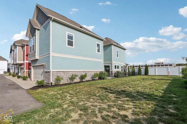 view of property exterior featuring a yard and a garage