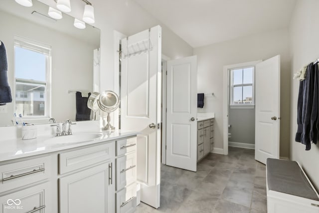 bathroom with tile patterned flooring, vanity, and toilet