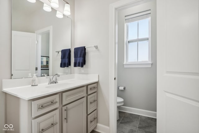 bathroom featuring tile patterned flooring, toilet, and vanity