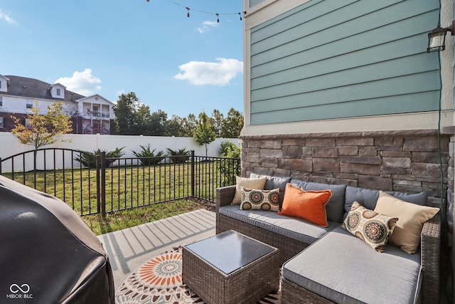 deck with an outdoor living space, grilling area, and a lawn