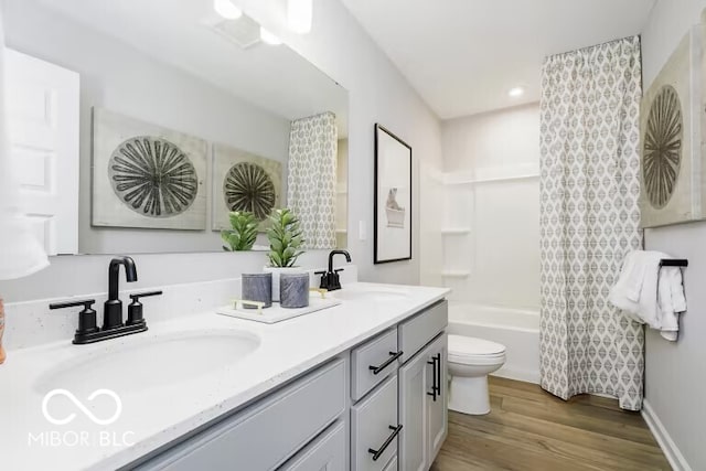 full bathroom featuring hardwood / wood-style floors, toilet, shower / tub combo, and vanity