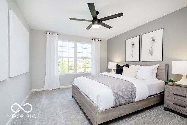 bedroom featuring light colored carpet and ceiling fan