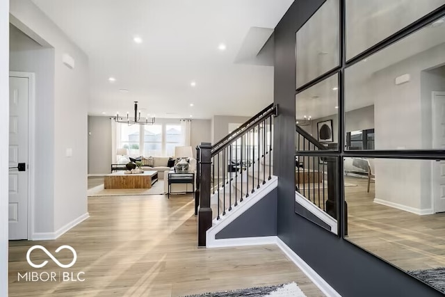 interior space with light hardwood / wood-style floors and a notable chandelier