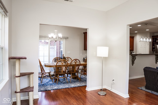 dining room featuring dark wood-type flooring and a chandelier