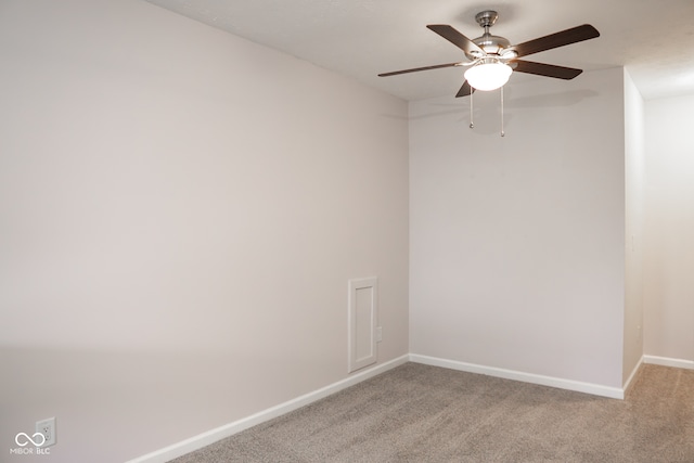 unfurnished room with ceiling fan and carpet