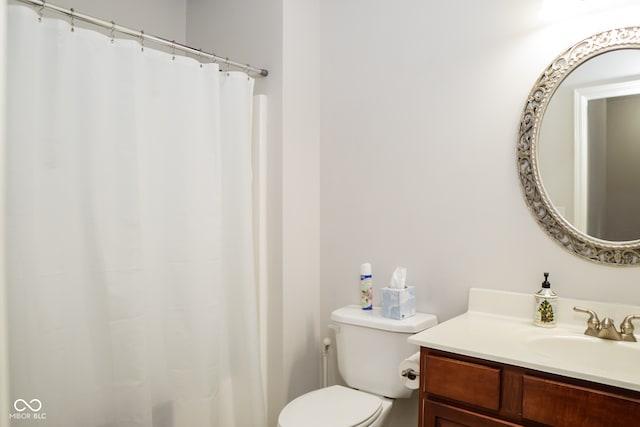 bathroom featuring vanity, toilet, and a shower with shower curtain