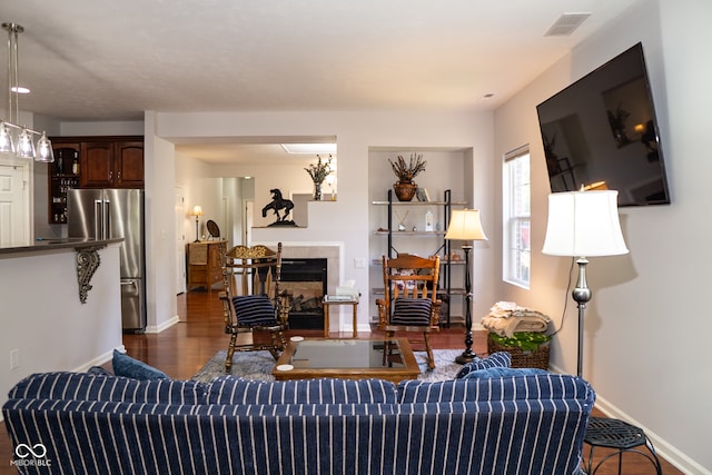 living room with dark hardwood / wood-style flooring