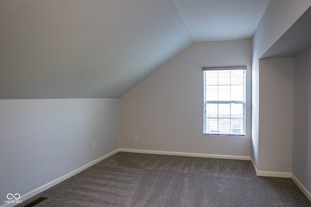 bonus room with lofted ceiling and carpet