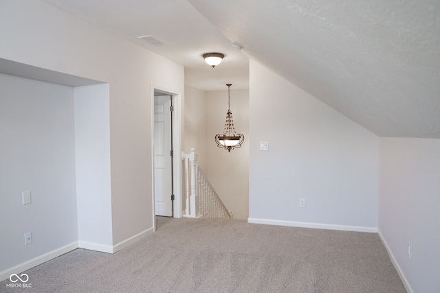 bonus room featuring carpet and vaulted ceiling