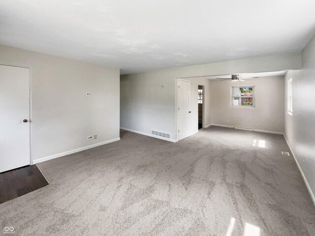 4013 N Graham Ave, Indianapolis, IN 46226 - unfurnished living room featuring carpet, baseboards, and a ceiling fan