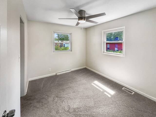 4013 N Graham Ave, Indianapolis, IN 46226 - carpeted empty room with ceiling fan, a baseboard heating unit, and baseboards