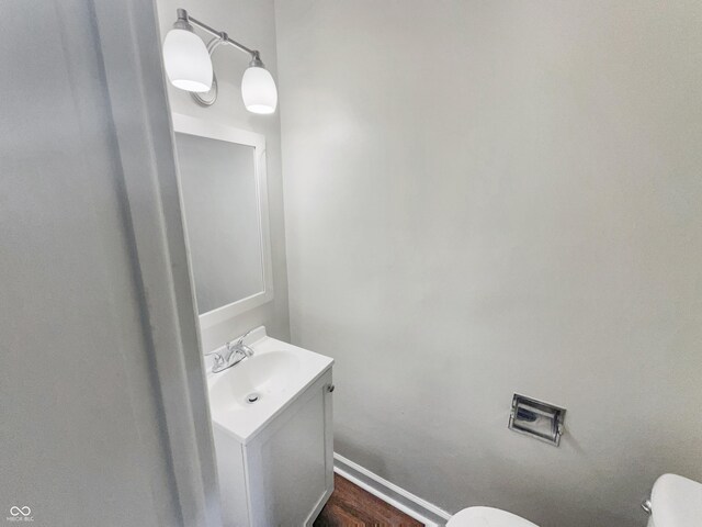 4013 N Graham Ave, Indianapolis, IN 46226 - half bathroom with toilet, vanity, and wood finished floors