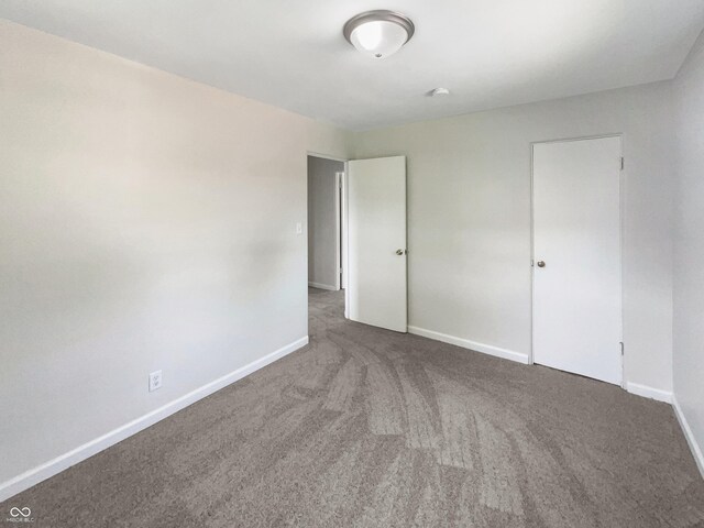 4013 N Graham Ave, Indianapolis, IN 46226 - unfurnished bedroom with baseboards and carpet