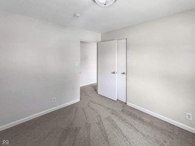 4013 N Graham Ave, Indianapolis, IN 46226 - unfurnished bedroom featuring carpet floors and baseboards