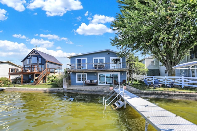 view of dock with a deck with water view