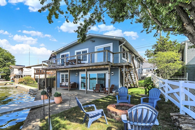 back of house featuring a balcony, an outdoor fire pit, and a patio