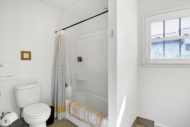 bathroom with toilet and shower / tub combo with curtain