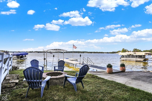 dock area with a fire pit and a water view