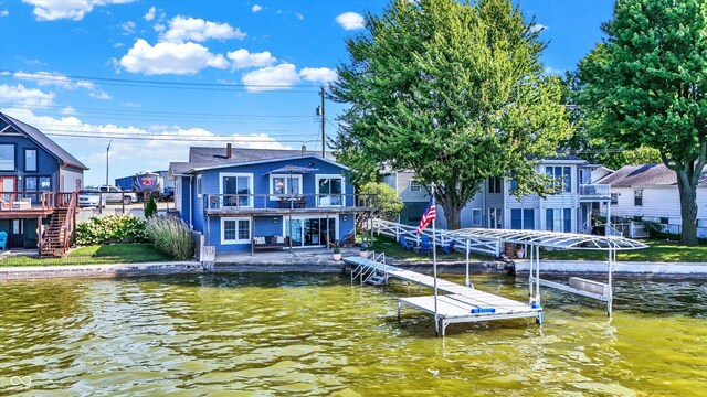 dock area featuring a balcony and a deck with water view