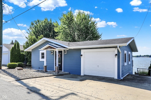 view of front of house with a water view and a garage