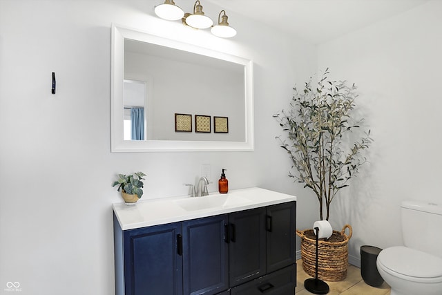 bathroom featuring tile patterned flooring, toilet, and vanity