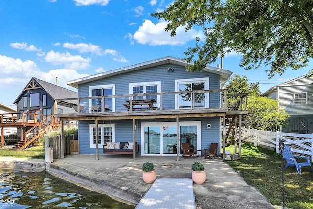 rear view of house with a deck and a patio