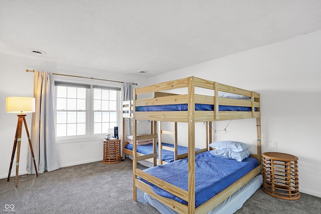 bedroom featuring a textured ceiling and carpet flooring