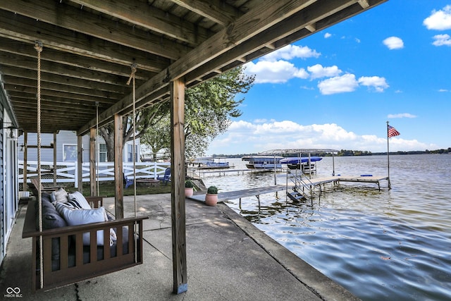 view of dock featuring an outdoor living space and a water view