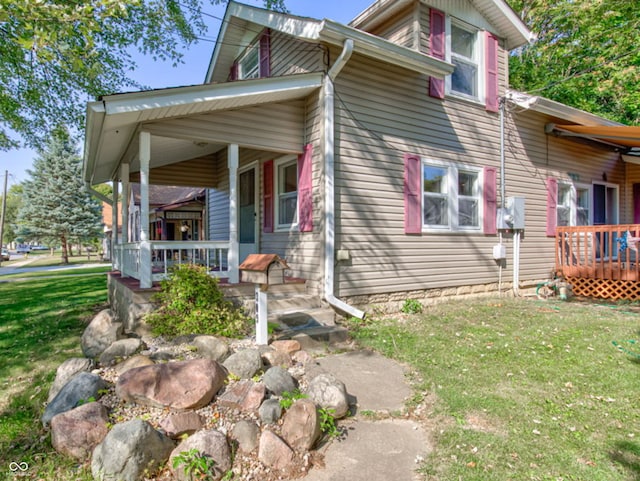 view of front of house with a front yard and a porch