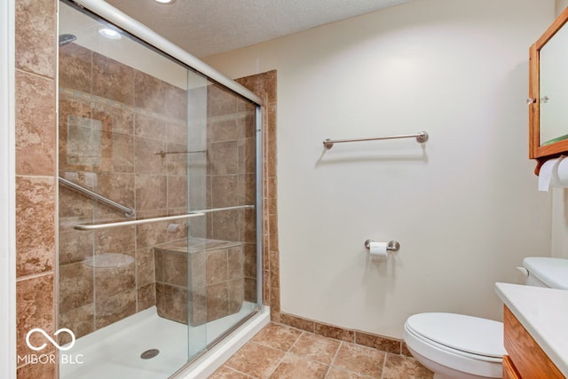 bathroom featuring vanity, an enclosed shower, a textured ceiling, tile patterned floors, and toilet