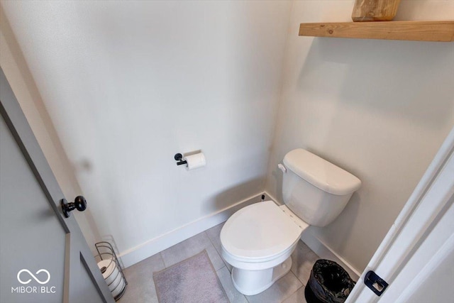 bathroom featuring baseboards, toilet, and tile patterned floors