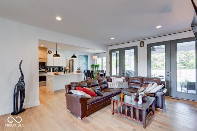 living room with french doors, light wood-type flooring, visible vents, and recessed lighting