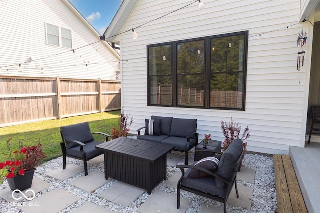 view of patio featuring fence and an outdoor hangout area