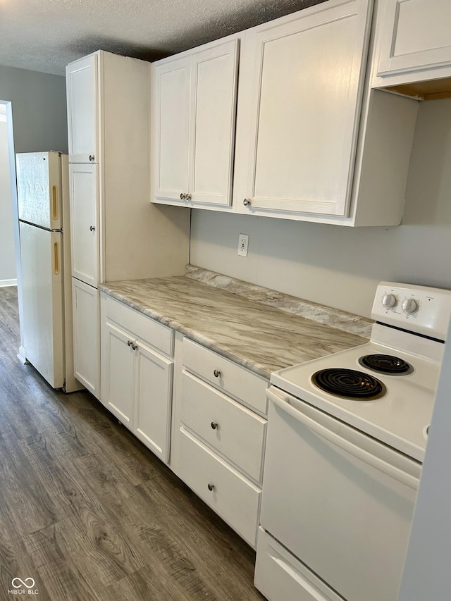 kitchen featuring white appliances, white cabinetry, dark wood finished floors, and a textured ceiling